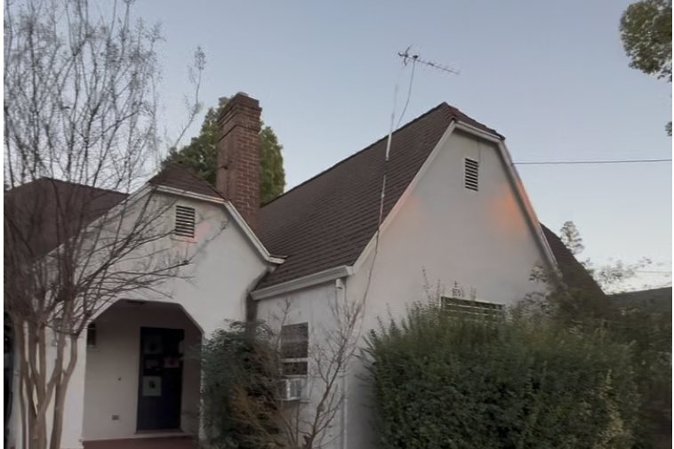 Olive Street house in Yuba City before renovation, overgrown shrubs against the front elevation
